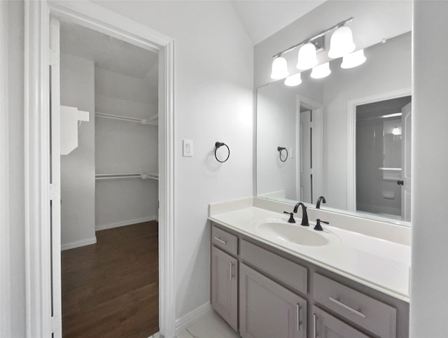 1832 Olney Dr, Allen, TX 75013 - full bathroom with vanity, wood finished floors, a shower, lofted ceiling, and a walk in closet