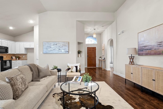60 N Highland Dr, Sanger, TX 76266 - living area featuring arched walkways, vaulted ceiling, and dark wood-type flooring