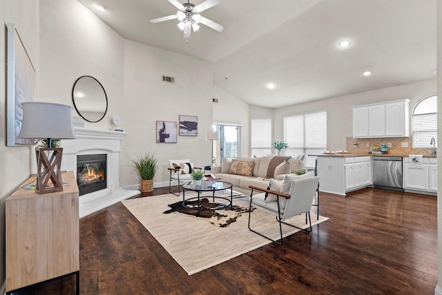 60 N Highland Dr, Sanger, TX 76266 - living area with ceiling fan, plenty of natural light, dark wood finished floors, a glass covered fireplace, and recessed lighting