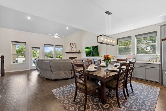 216 Shadow Creek Ln, Hickory Creek, TX 75065 - dining area with a warm lit fireplace, a ceiling fan, dark wood-style floors, recessed lighting, and high vaulted ceiling
