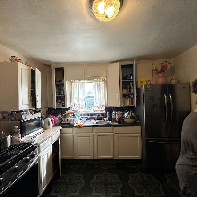 4028 Forbes St, Fort Worth, TX 76105 - kitchen featuring freestanding refrigerator, gas range oven, backsplash, and stainless steel microwave
