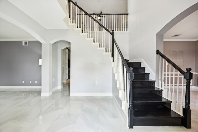 433 Willow Bend Dr, Murphy, TX 75094 - staircase featuring arched walkways, ornamental molding, and a towering ceiling