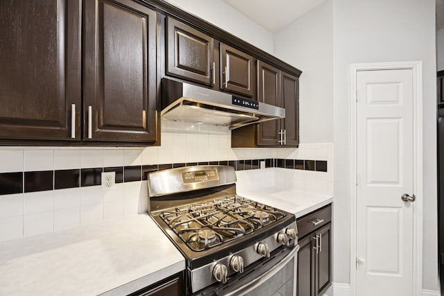 433 Willow Bend Dr, Murphy, TX 75094 - kitchen featuring stainless steel gas stove, under cabinet range hood, light countertops, and dark brown cabinetry