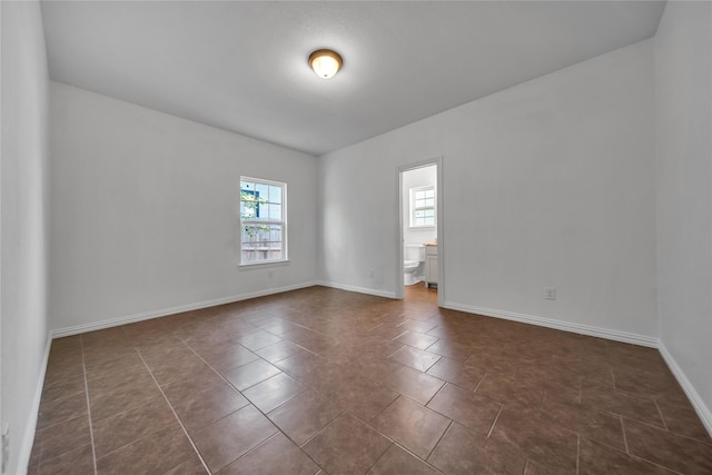 2522 Refugio Ave, Fort Worth, TX 76164 - empty room featuring dark tile patterned floors and baseboards