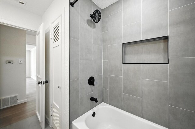 5416 Purington Ave, Fort Worth, TX 76112 - bathroom with bathtub / shower combination and wood finished floors