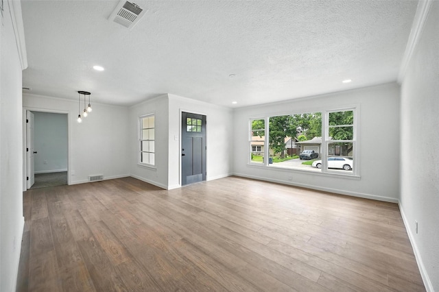 5416 Purington Ave, Fort Worth, TX 76112 - unfurnished living room featuring a textured ceiling, wood finished floors, recessed lighting, and ornamental molding