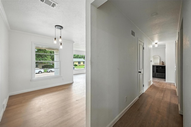 5416 Purington Ave, Fort Worth, TX 76112 - corridor with a textured ceiling, wood finished floors, and ornamental molding