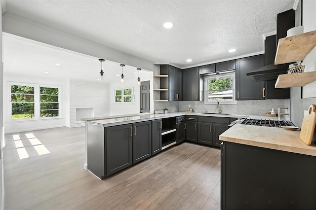 5416 Purington Ave, Fort Worth, TX 76112 - kitchen featuring open shelves, light wood-type flooring, butcher block counters, decorative backsplash, and recessed lighting