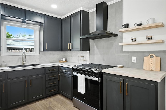 5416 Purington Ave, Fort Worth, TX 76112 - kitchen featuring stainless steel gas range oven, wall chimney range hood, light countertops, backsplash, and a textured ceiling
