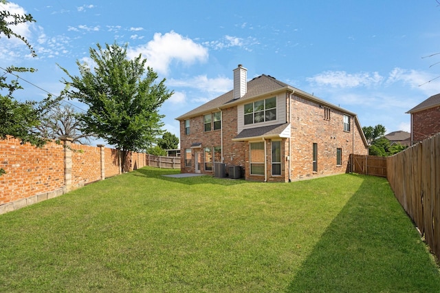 13317 Spinning Glen St, Fort Worth, TX 76040 - back of house with a fenced backyard, a chimney, and brick siding