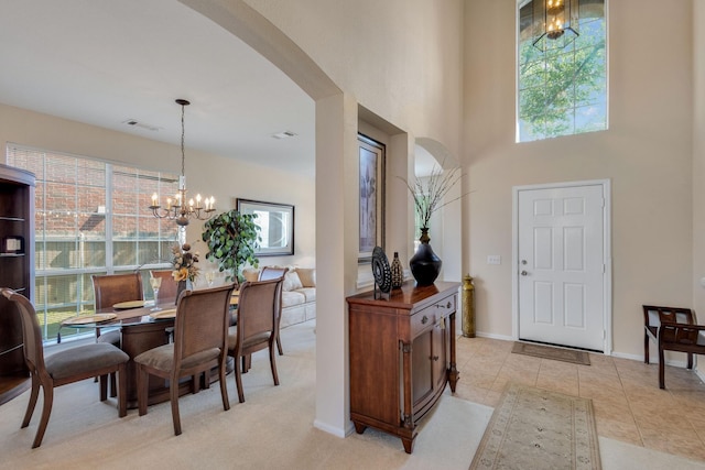 13317 Spinning Glen St, Fort Worth, TX 76040 - dining room with arched walkways, a chandelier, healthy amount of natural light, a high ceiling, and light tile patterned flooring