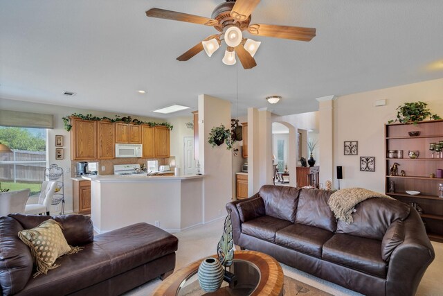 13317 Spinning Glen St, Fort Worth, TX 76040 - living room featuring a ceiling fan, light carpet, and arched walkways