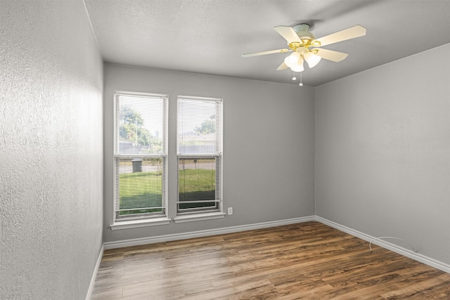 5207 Atlantis Ter, Arlington, TX 76016 - empty room with wood finished floors, ceiling fan, and a textured wall