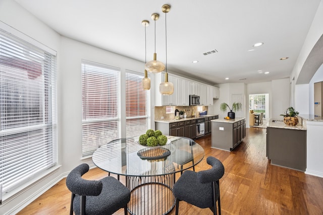 5725 Gerber Ter, Plano, TX 75094 - dining room with healthy amount of natural light, wood finished floors, and recessed lighting