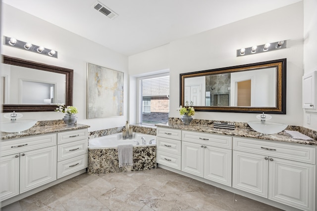 5725 Gerber Ter, Plano, TX 75094 - bathroom featuring two vanities and a garden tub