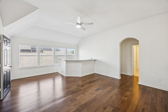 5725 Gerber Ter, Plano, TX 75094 - unfurnished living room featuring a ceiling fan, arched walkways, dark wood-style floors, and lofted ceiling