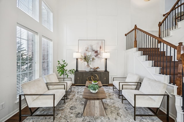 5725 Gerber Ter, Plano, TX 75094 - living area featuring a towering ceiling, stairs, and wood finished floors
