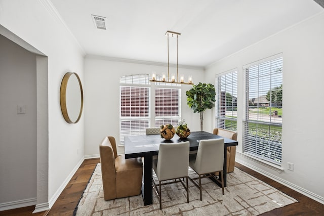 5725 Gerber Ter, Plano, TX 75094 - dining area featuring wood finished floors, ornamental molding, and a chandelier