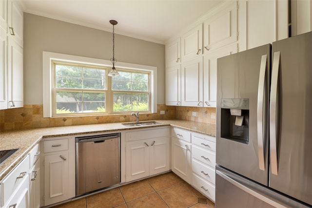 601 N 25th St, Corsicana, TX 75110 - kitchen featuring appliances with stainless steel finishes, backsplash, white cabinets, and ornamental molding