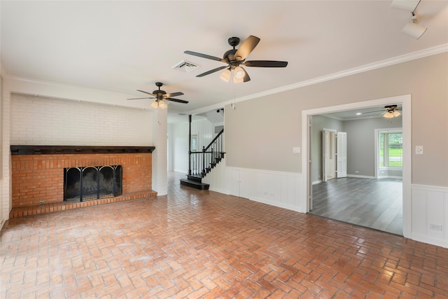 601 N 25th St, Corsicana, TX 75110 - unfurnished living room with a fireplace, ceiling fan, a wainscoted wall, ornamental molding, and brick floors