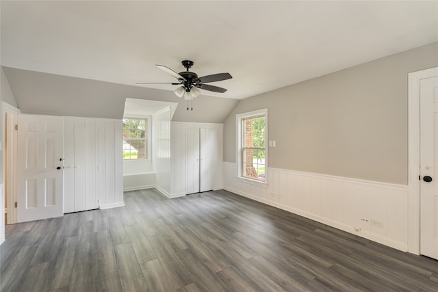 601 N 25th St, Corsicana, TX 75110 - unfurnished living room with a ceiling fan, lofted ceiling, dark wood finished floors, and wainscoting