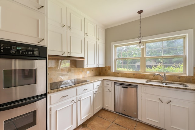 601 N 25th St, Corsicana, TX 75110 - kitchen with stainless steel appliances, decorative backsplash, ornamental molding, white cabinets, and light stone countertops