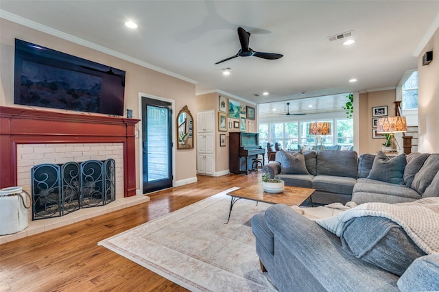 3700 Red Oak Dr, Corinth, TX 76208 - living area featuring ceiling fan, ornamental molding, wood finished floors, recessed lighting, and a brick fireplace