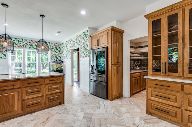 3700 Red Oak Dr, Corinth, TX 76208 - kitchen with stainless steel refrigerator with ice dispenser, wallpapered walls, brown cabinetry, wainscoting, and glass insert cabinets