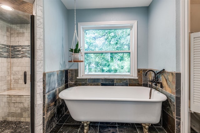 3700 Red Oak Dr, Corinth, TX 76208 - full bathroom with tile walls, a soaking tub, a shower stall, wainscoting, and a closet