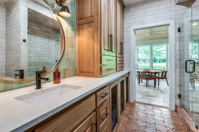3700 Red Oak Dr, Corinth, TX 76208 - bathroom with vanity, a shower stall, and stone finish flooring