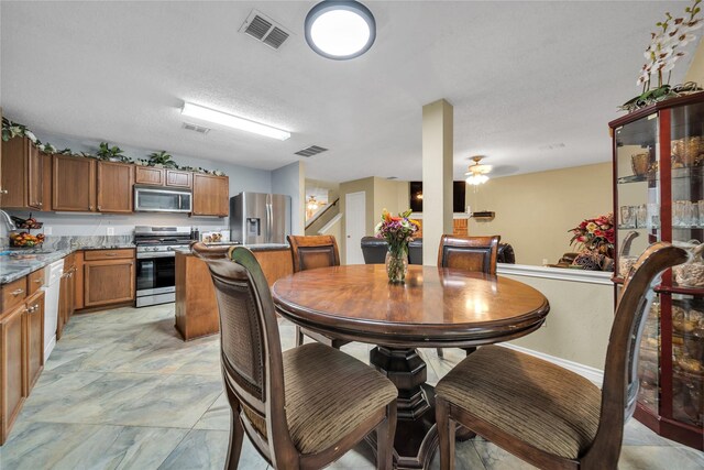 1032 Hampton Dr, Forney, TX 75126 - dining area with a ceiling fan and a textured ceiling