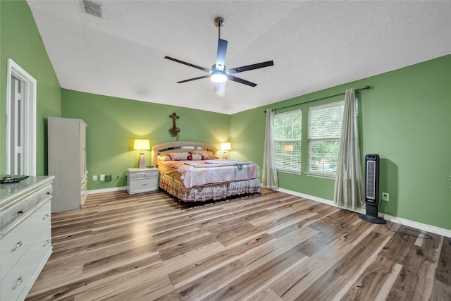1032 Hampton Dr, Forney, TX 75126 - bedroom featuring wood finished floors, a textured ceiling, ceiling fan, and lofted ceiling