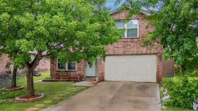 1032 Hampton Dr, Forney, TX 75126 - view of property hidden behind natural elements with brick siding, concrete driveway, an attached garage, and a front lawn