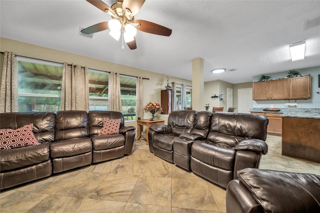 1032 Hampton Dr, Forney, TX 75126 - living area featuring ceiling fan and a textured ceiling