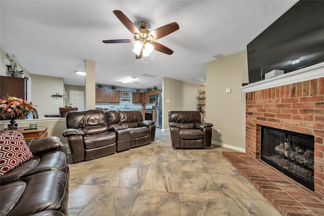 1032 Hampton Dr, Forney, TX 75126 - living area featuring a ceiling fan, a fireplace, and a textured ceiling