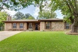 7820 Kermit Ave, Fort Worth, TX 76116 - ranch-style house featuring a chimney, a front yard, stone siding, and concrete driveway