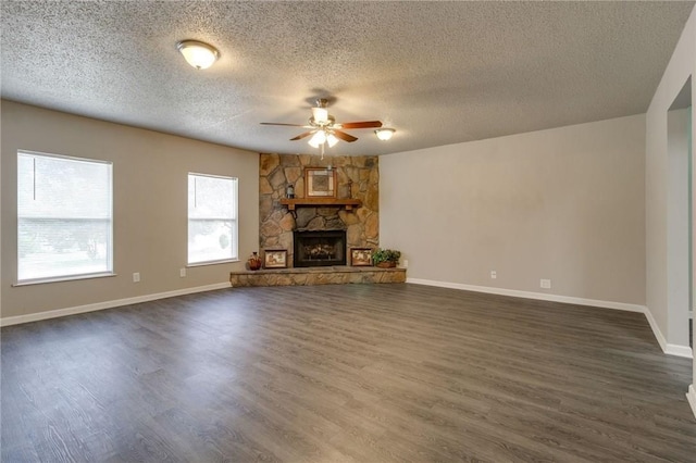 7820 Kermit Ave, Fort Worth, TX 76116 - unfurnished living room with ceiling fan, dark wood-style floors, a textured ceiling, and a fireplace
