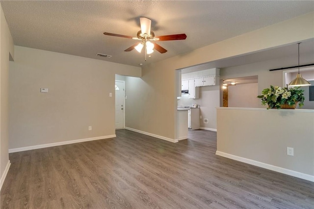 7820 Kermit Ave, Fort Worth, TX 76116 - unfurnished room featuring a ceiling fan, dark wood-style flooring, and a textured ceiling