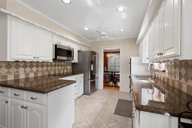 10707 Ferndale Rd, Dallas, TX 75238 - kitchen with stainless steel appliances, white cabinetry, light tile patterned flooring, a ceiling fan, and recessed lighting