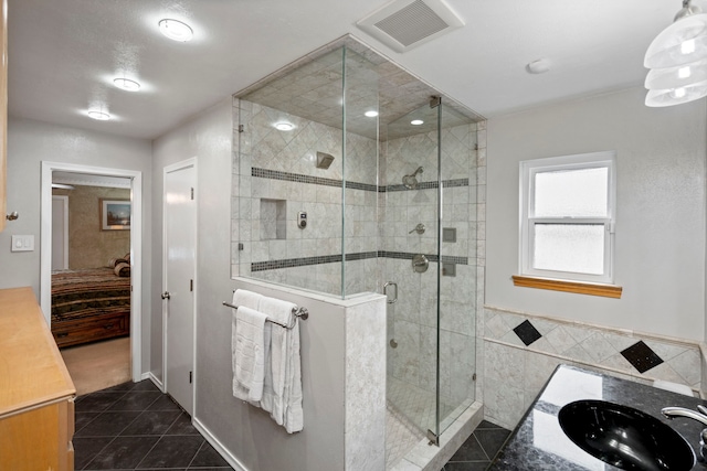 10707 Ferndale Rd, Dallas, TX 75238 - ensuite bathroom featuring tile patterned floors, a shower stall, vanity, and tile walls