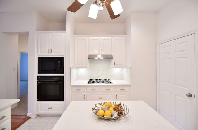 2505 Spring Hill Ln E, Garland, TX 75044 - kitchen with black appliances, ceiling fan, under cabinet range hood, backsplash, and white cabinetry