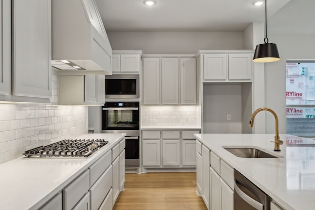 4505 N Summit View Dr, Mckinney, TX 75071 - kitchen with appliances with stainless steel finishes, light countertops, custom exhaust hood, decorative light fixtures, and tasteful backsplash