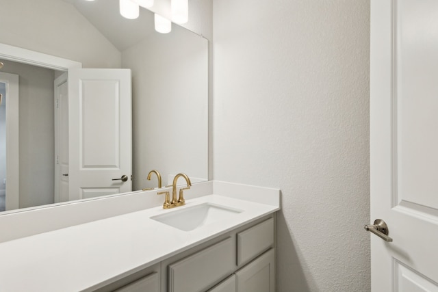 4505 N Summit View Dr, Mckinney, TX 75071 - bathroom featuring vanity, a textured wall, and vaulted ceiling