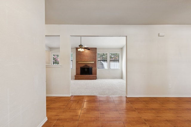 5602 Overridge Dr, Arlington, TX 76017 - unfurnished living room with ceiling fan, a brick fireplace, and wood finished floors