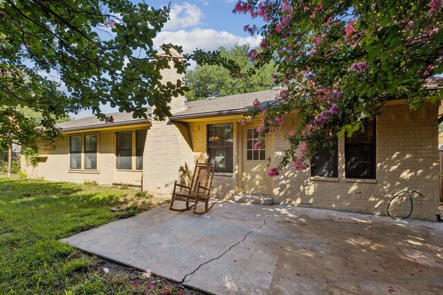 5602 Overridge Dr, Arlington, TX 76017 - rear view of property with a patio area, a yard, and brick siding