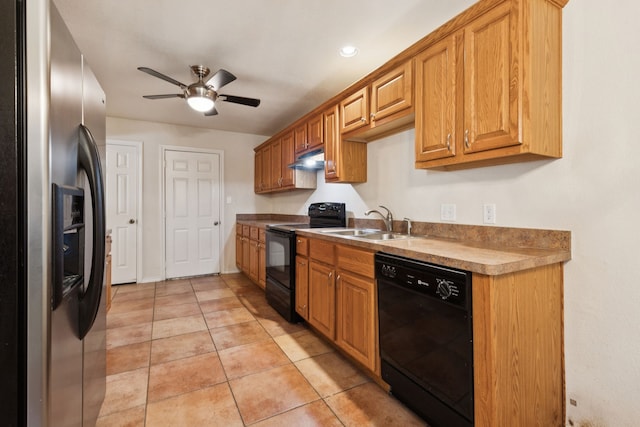 5602 Overridge Dr, Arlington, TX 76017 - kitchen featuring black appliances, a ceiling fan, under cabinet range hood, light tile patterned floors, and brown cabinetry