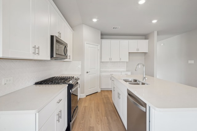 117 Whitlow Dr, Princeton, TX 75071 - kitchen featuring stainless steel appliances, light wood finished floors, recessed lighting, decorative backsplash, and a kitchen island with sink