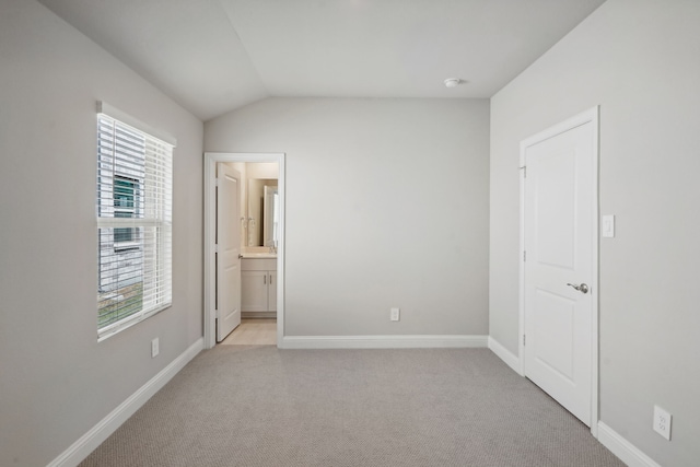 117 Whitlow Dr, Princeton, TX 75071 - unfurnished bedroom featuring light colored carpet, lofted ceiling, and ensuite bath