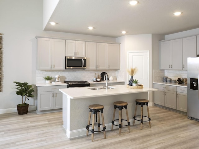 201 Whitlow Dr, Princeton, TX 75071 - kitchen featuring stainless steel appliances, gray cabinetry, tasteful backsplash, an island with sink, and recessed lighting