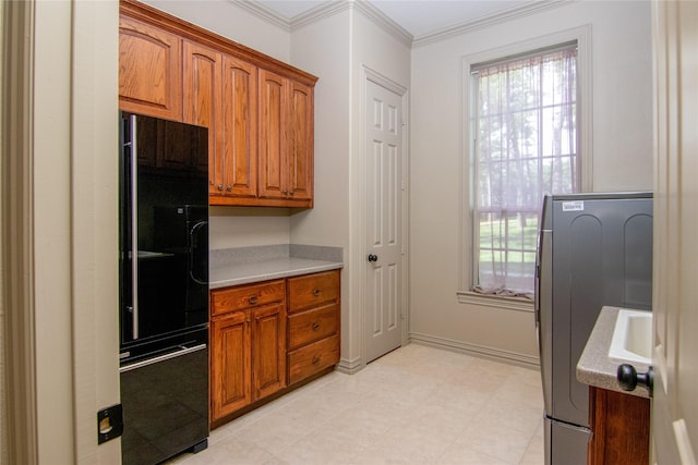 10111 Bluffview Cir, Pilot Point, TX 76258 - kitchen with freestanding refrigerator, brown cabinets, light countertops, and ornamental molding